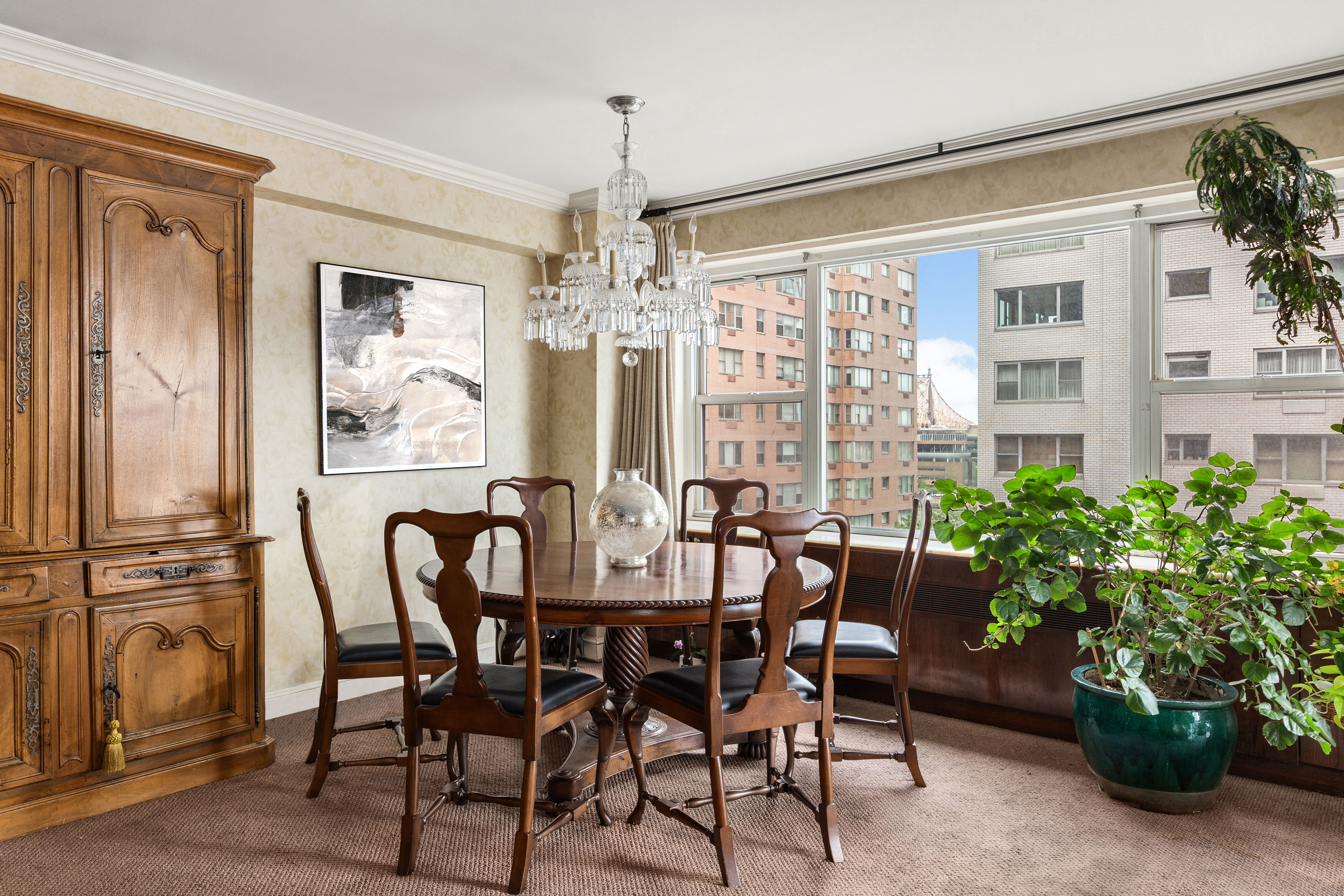 50 Sutton Place South, Unit 9F Manhattan, NY 10022 - Photo 3 of 10 a view of a dining room with furniture and chandelier
