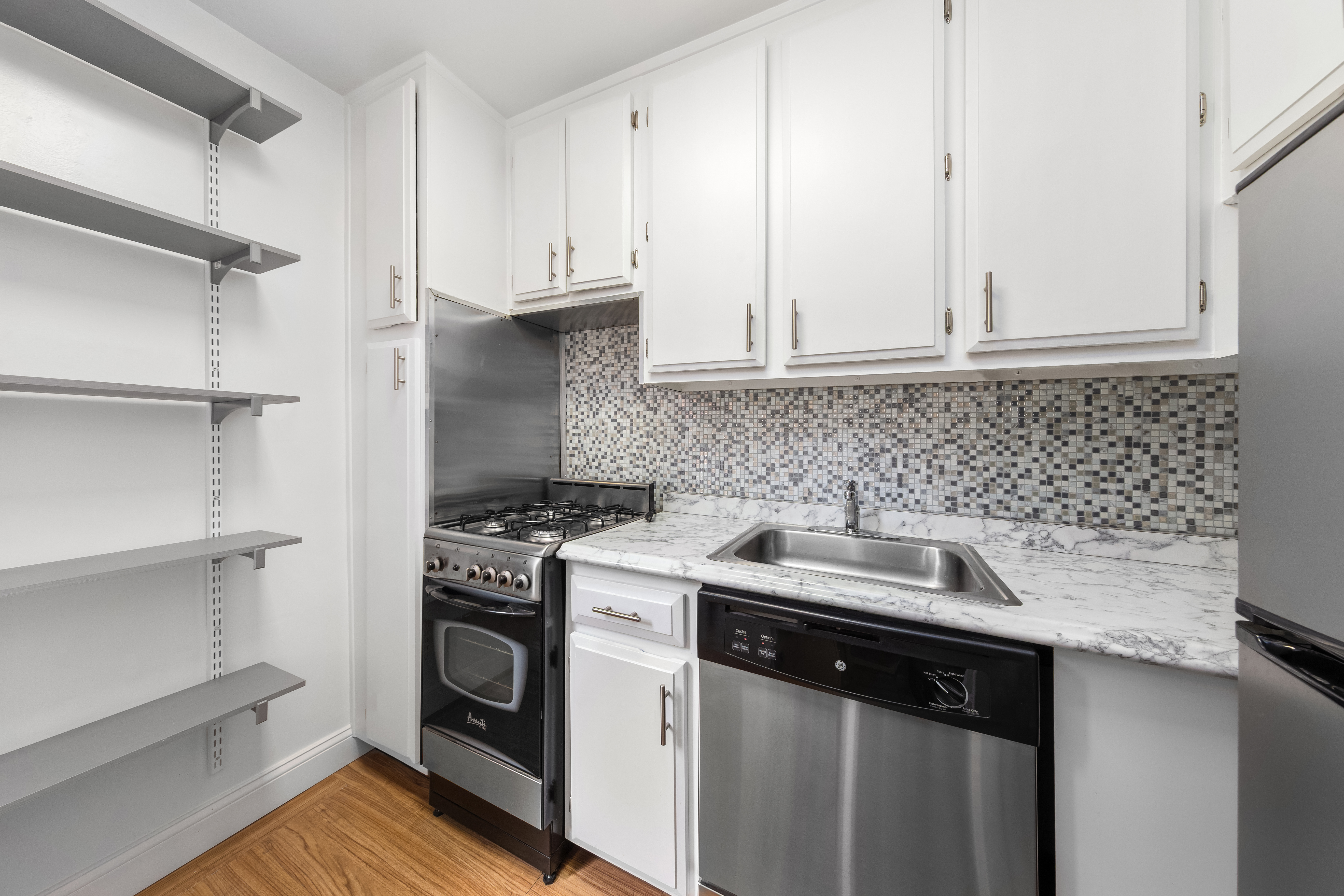 1160 3rd Avenue, Unit 3B Manhattan, NY 10065 - Photo 3 of 6 a kitchen with a sink cabinets and appliances