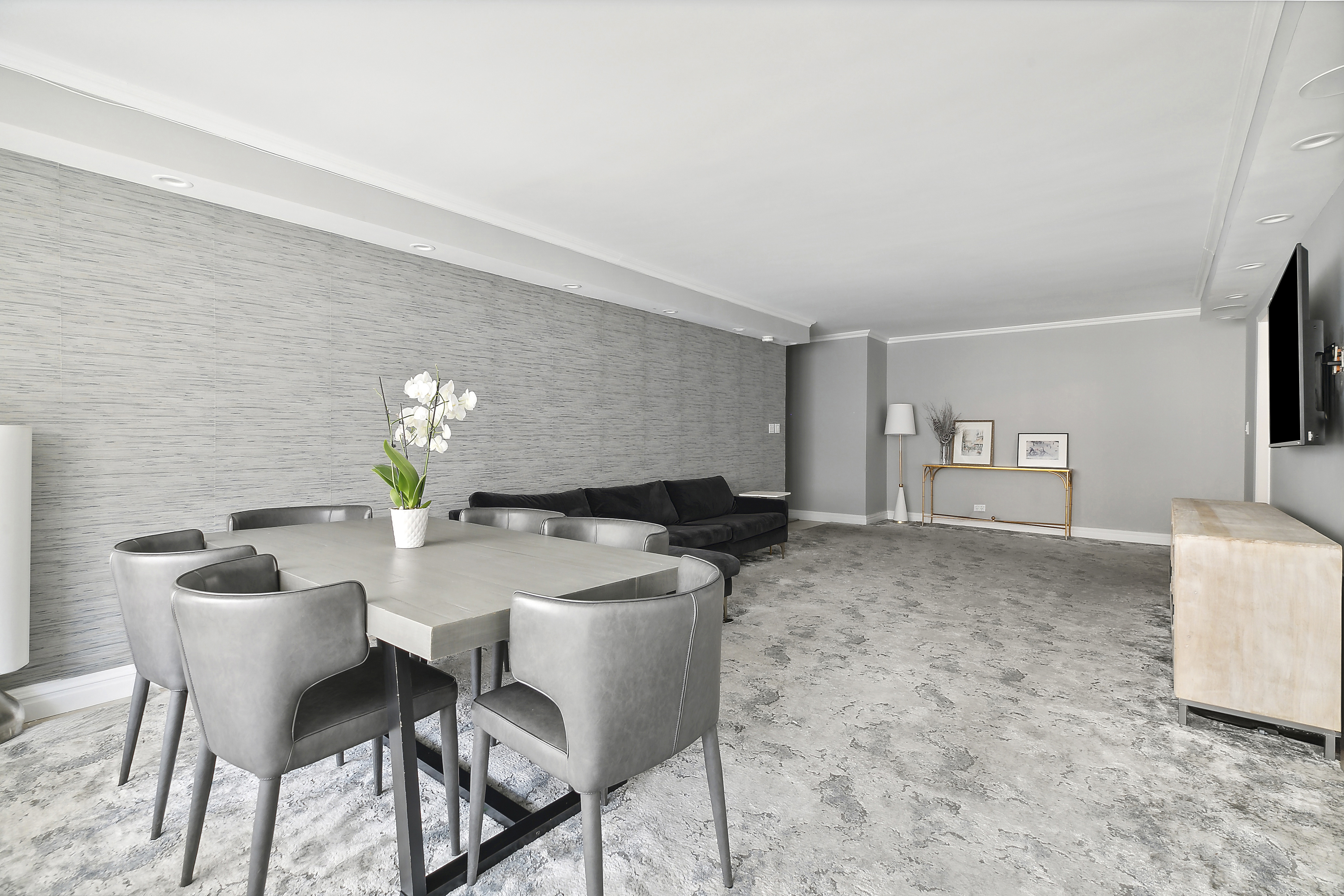 303 East 57th Street, Unit 11L Manhattan, NY 10022 - Photo 2 of 11 a living room with furniture and a flat screen tv