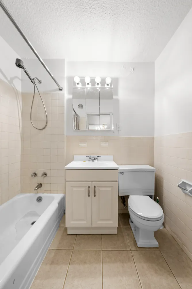 a bathroom with a sink a toilet and bathtub