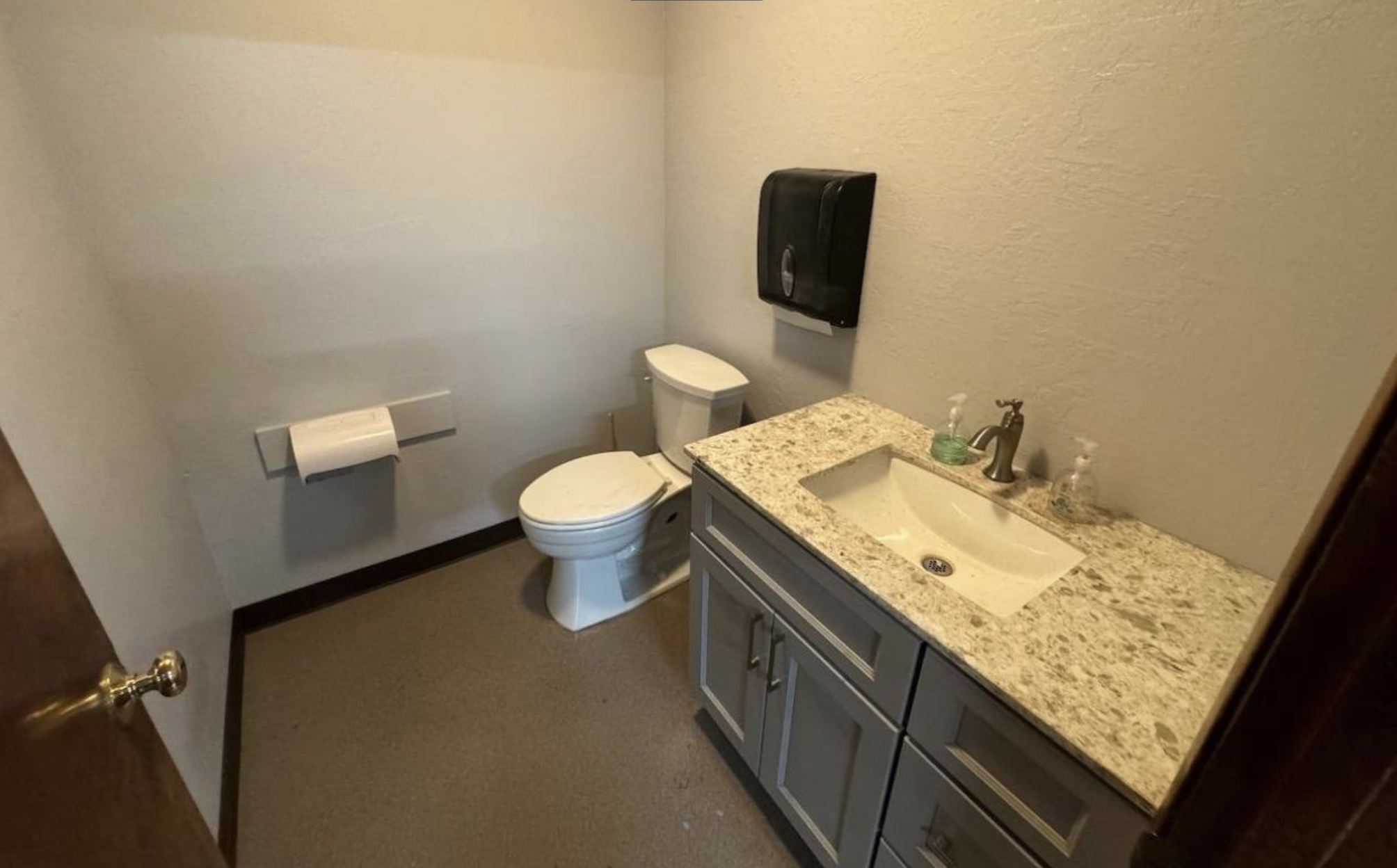 64 East St Charles Street San Andreas, CA 95249 - Photo 21 of 25 a bathroom with a granite countertop toilet and sink