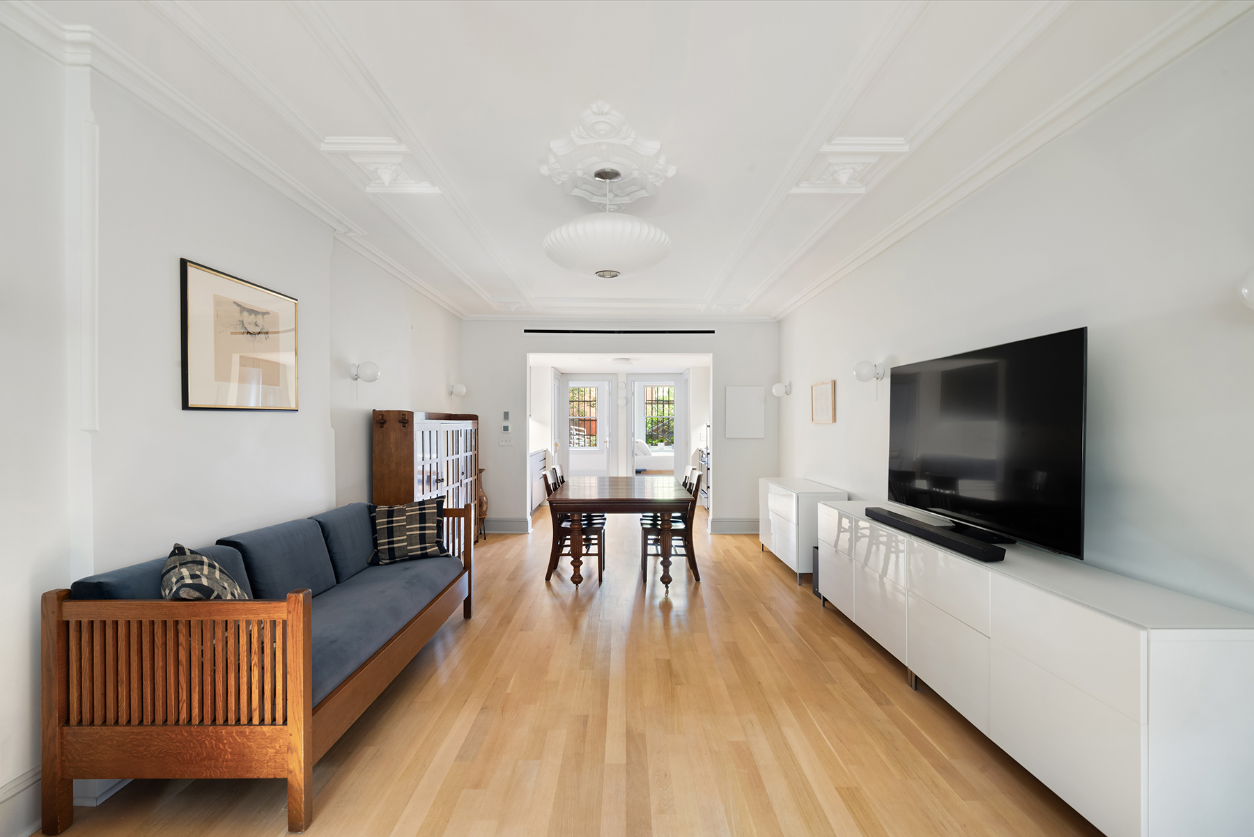 142 6th Avenue, Unit 1 Brooklyn, NY 11217 - Photo 2 of 14 a living room with furniture and a flat screen tv