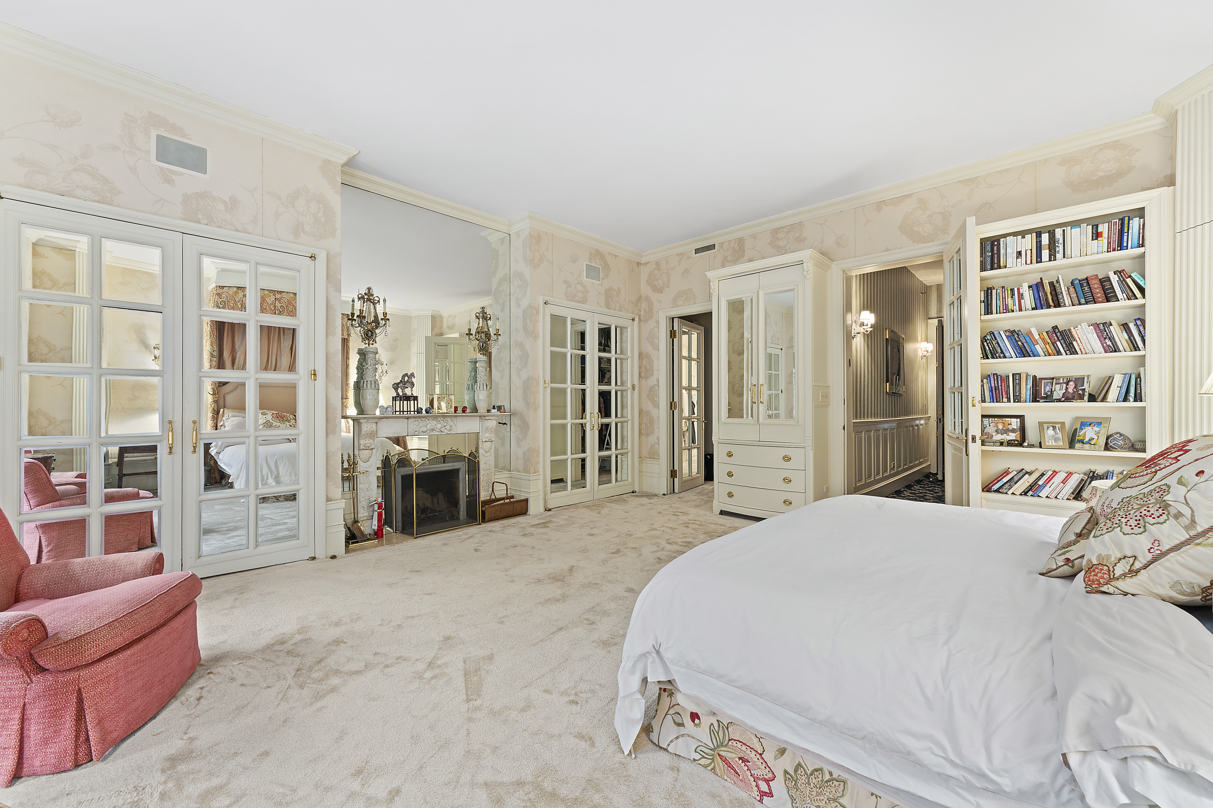 21 West 70th Street Manhattan, NY 10023 - Photo 3 of 12 a spacious bedroom with a bed a couch and walk in closet