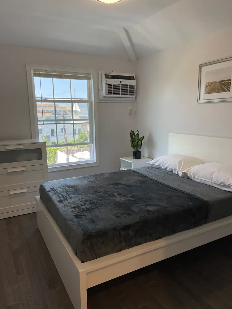 a bedroom with a bed and a window