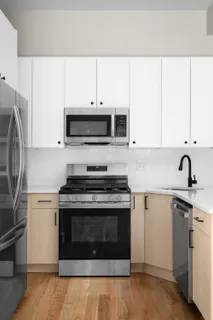 a kitchen with granite countertop a stove and a sink