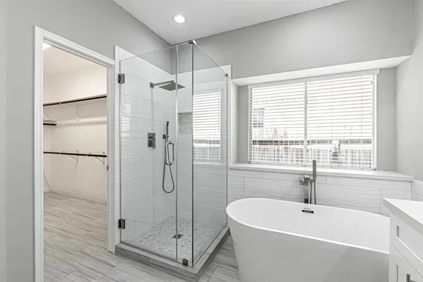 a bathroom with a bathtub and a shower