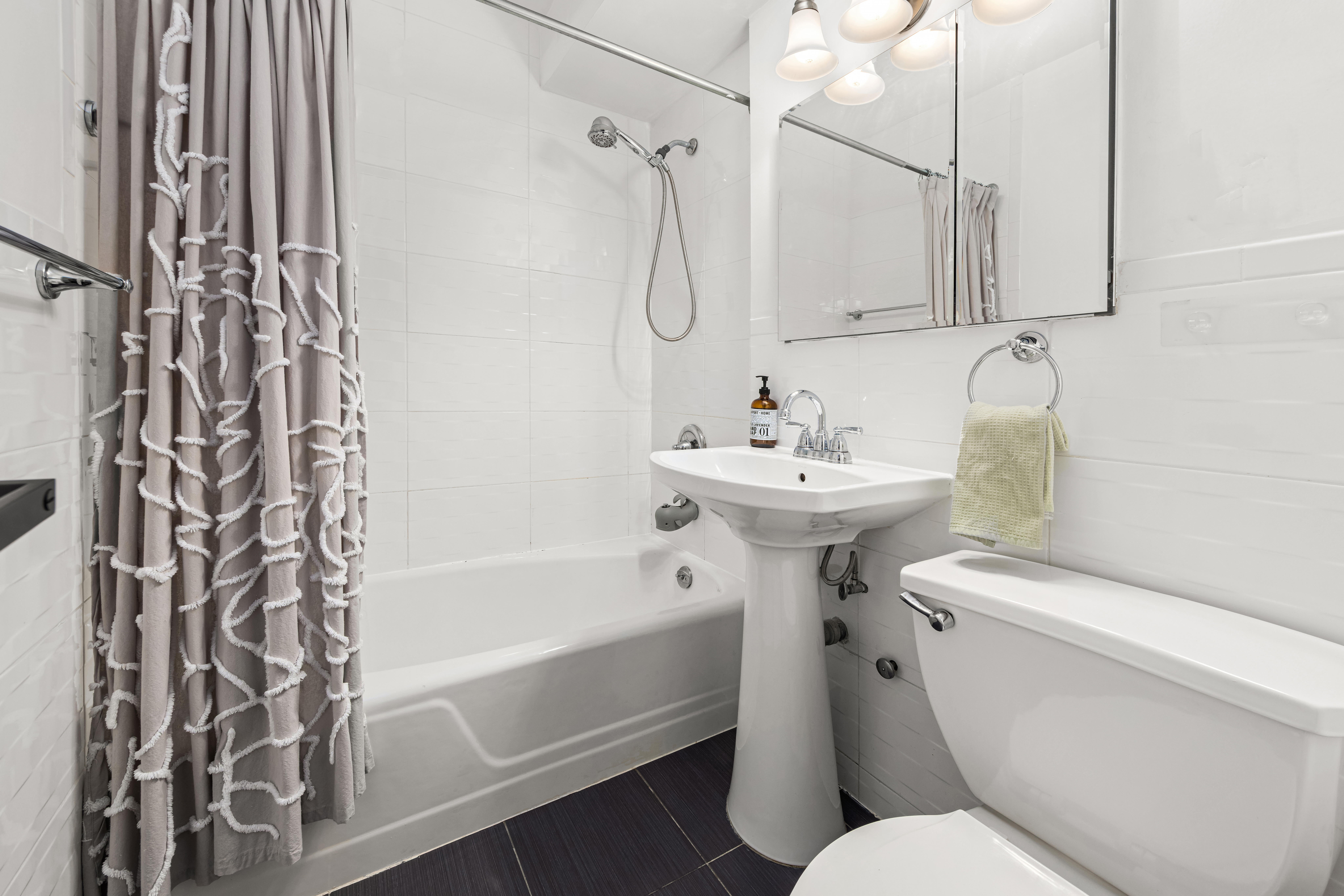 107-40 Queens Boulevard, Unit 11A Queens, NY 11375 - Photo 6 of 10 a bathroom with a sink toilet and shower