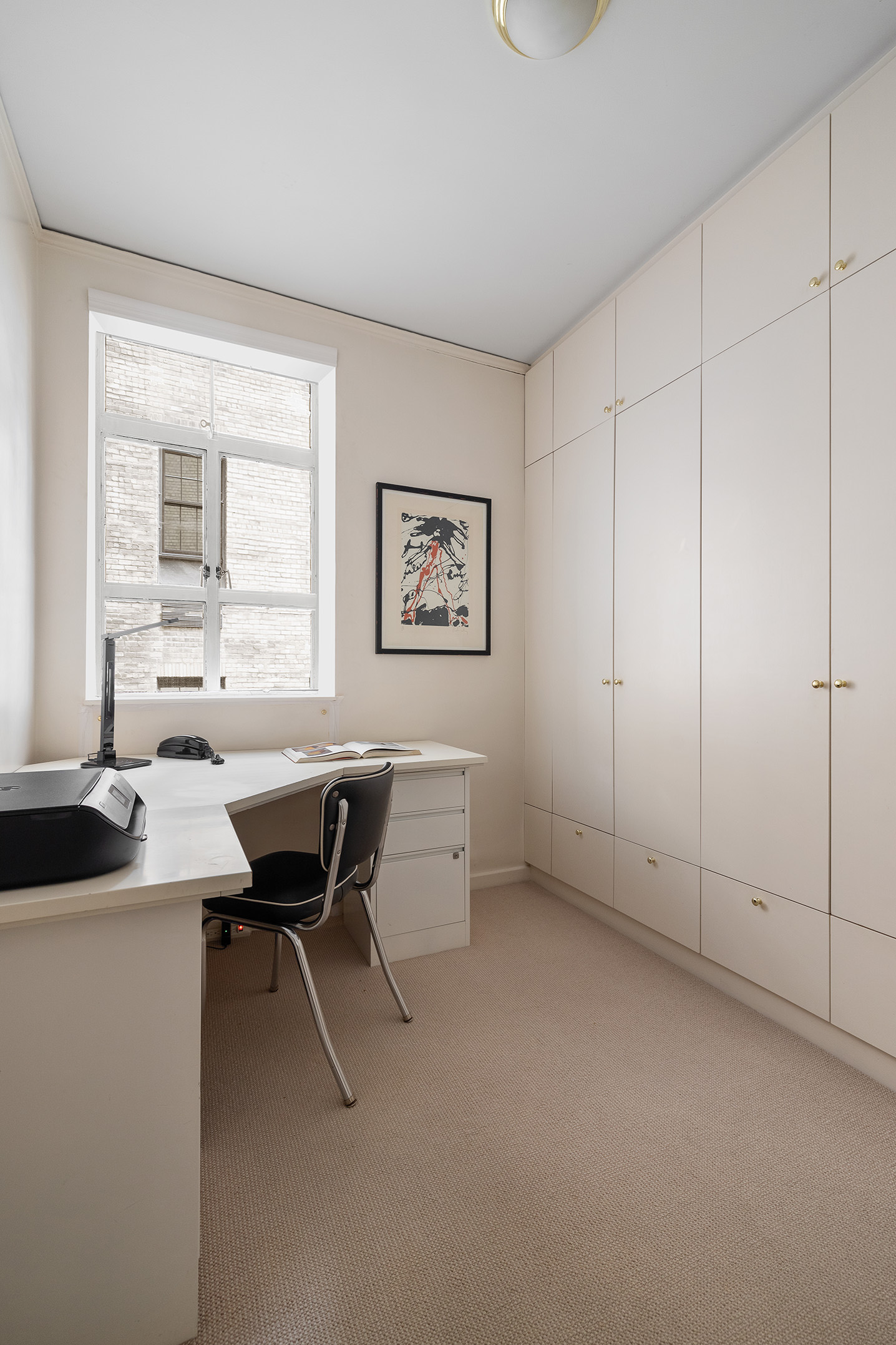 116 East 68th Street, Unit 2D Manhattan, NY 10065 - Photo 10 of 12 a view of a workspace with furniture and a window