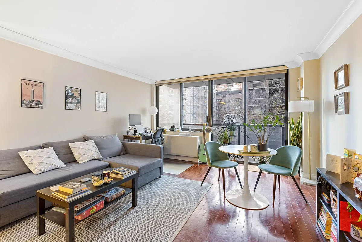 a living room with furniture and a floor to ceiling window