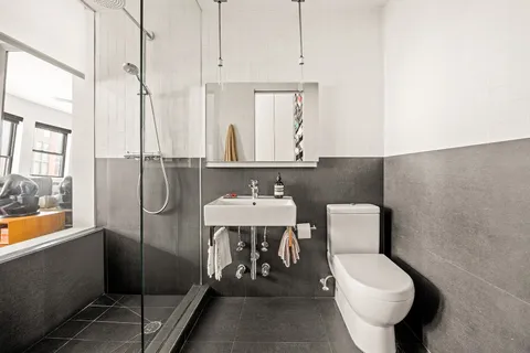 a bathroom with a toilet a sink and bathtub