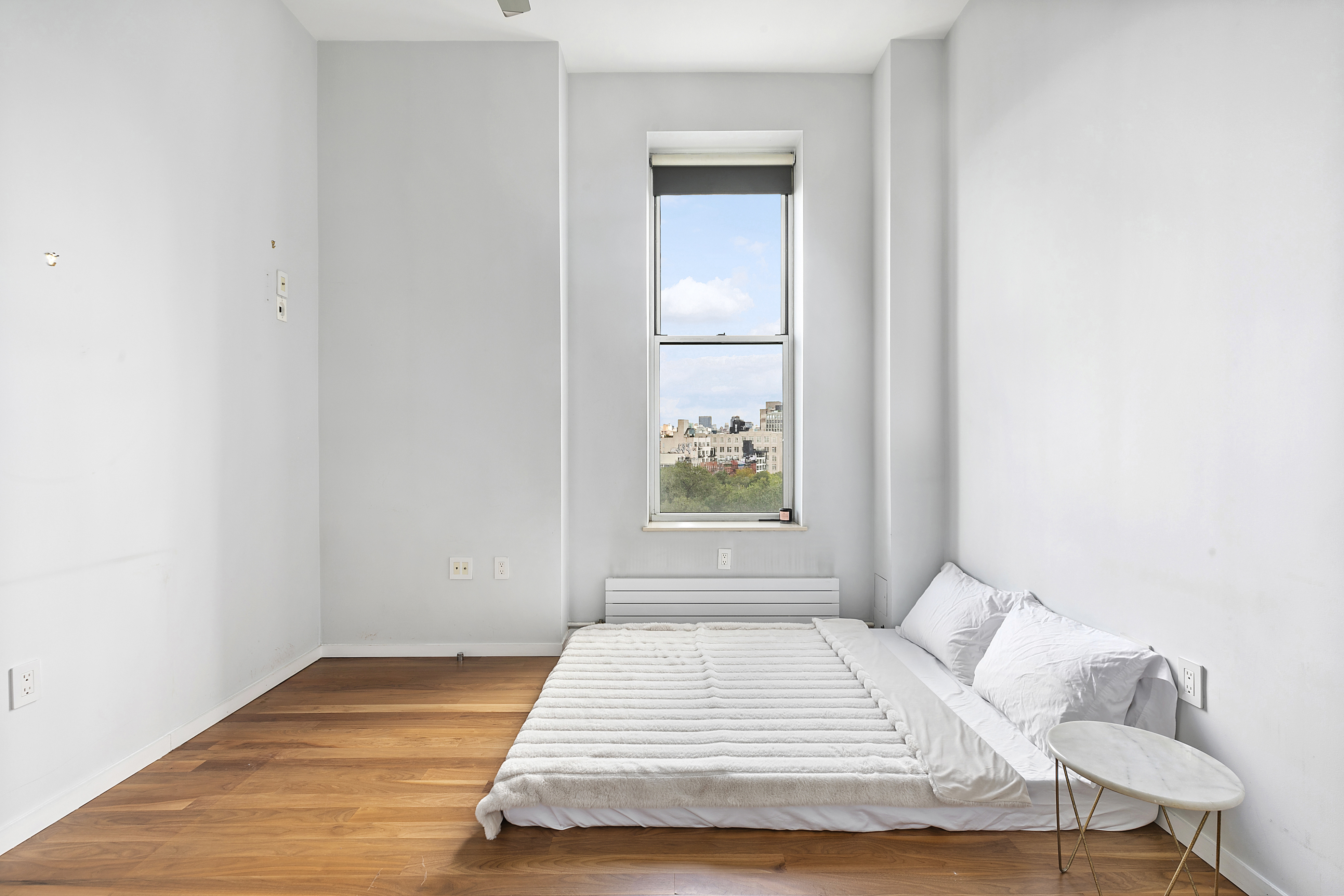 175 East Broadway, Unit 7A Manhattan, NY 10002 - Photo 4 of 9 a bedroom with a bed and a window