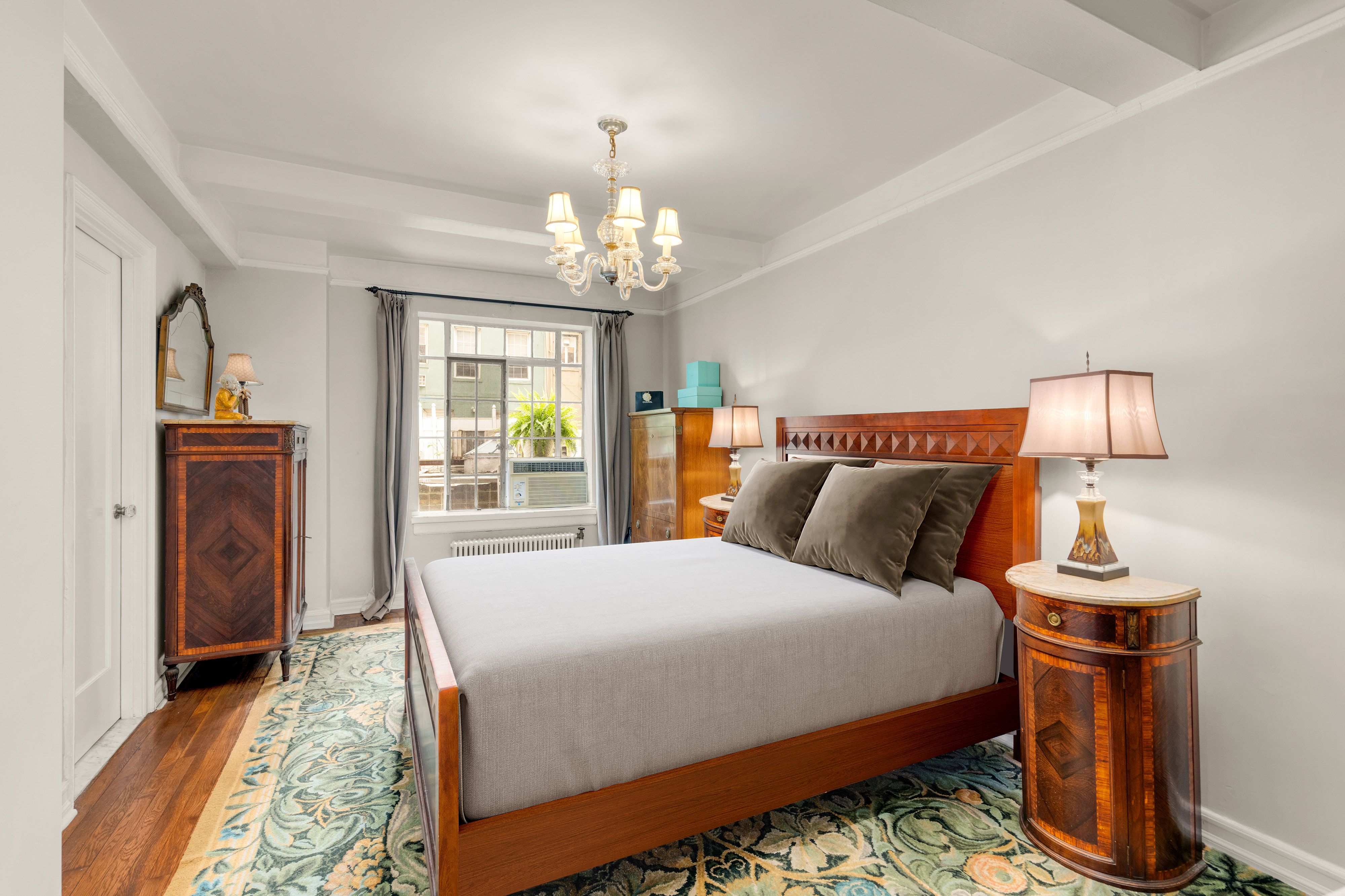 227 East 57th Street, Unit 2H Manhattan, NY 10022 - Photo 3 of 9 a bedroom with bed and wooden floor