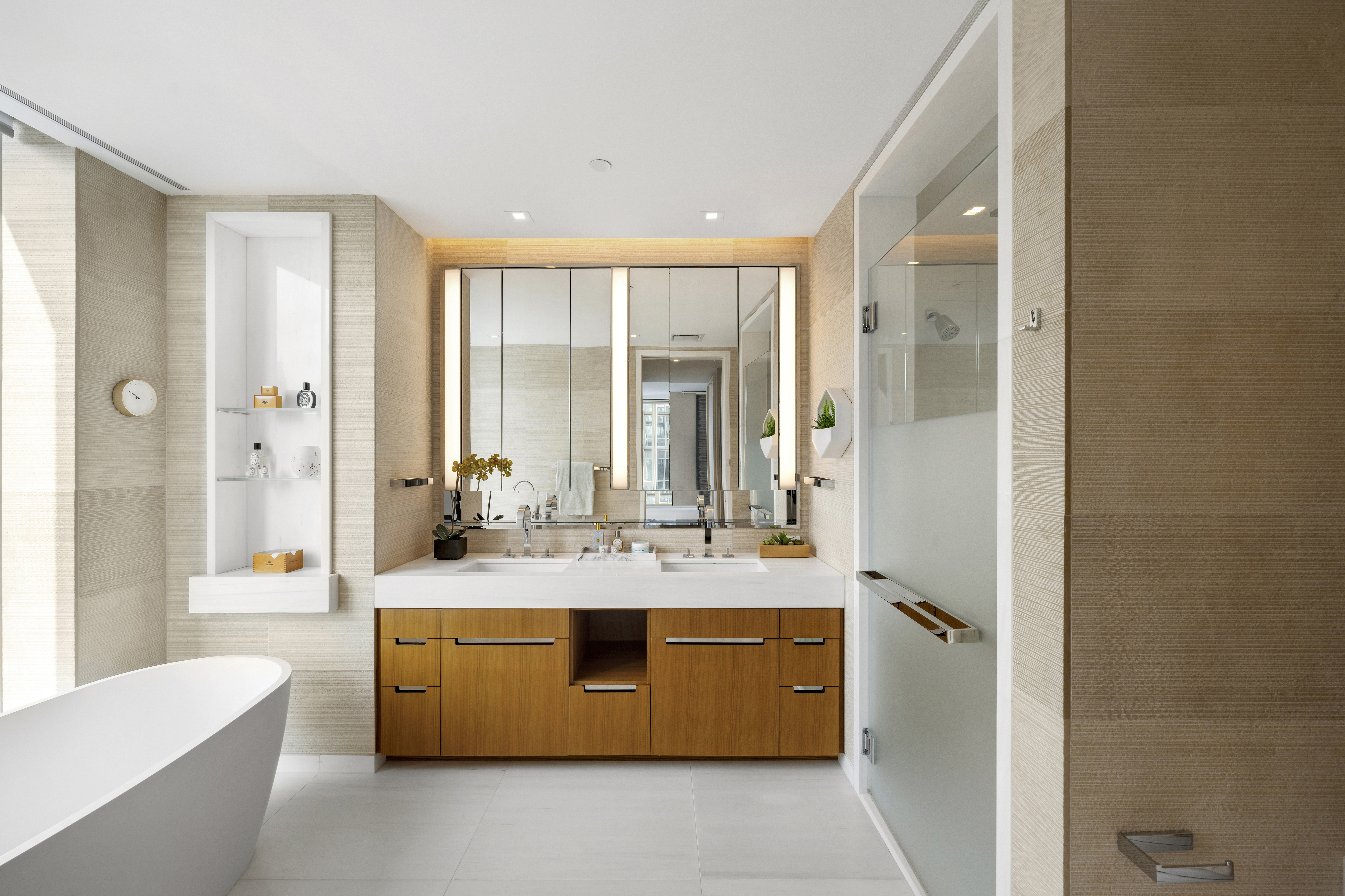 1 West End Avenue, Unit 22C Manhattan, NY 10023 - Photo 6 of 15 a en suite bathroom with a granite countertop double vanity sink a mirror and a bathtub
