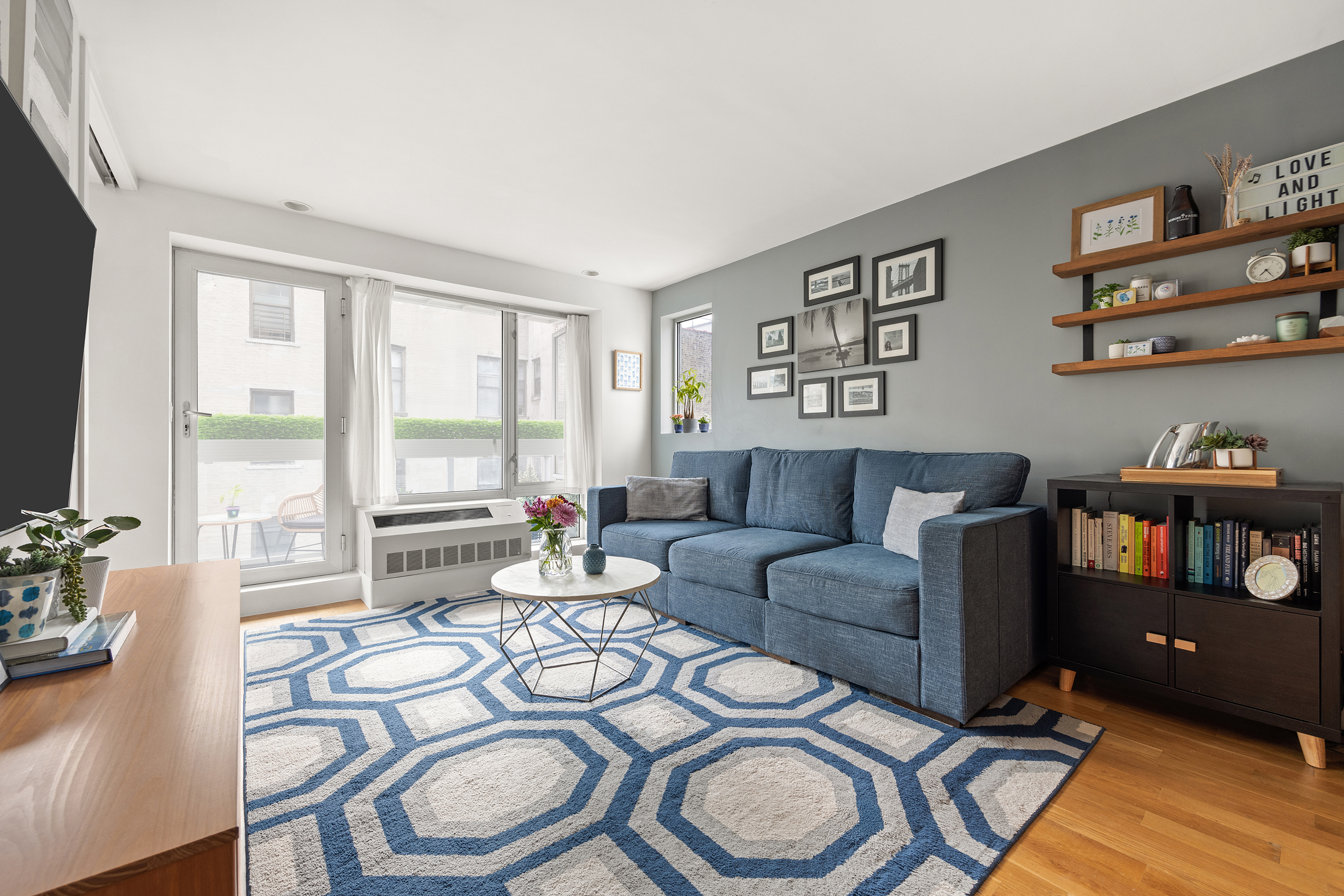 823 Classon Avenue, Unit 4B Brooklyn, NY 11238 - Photo 3 of 17 a living room with furniture and a floor to ceiling window