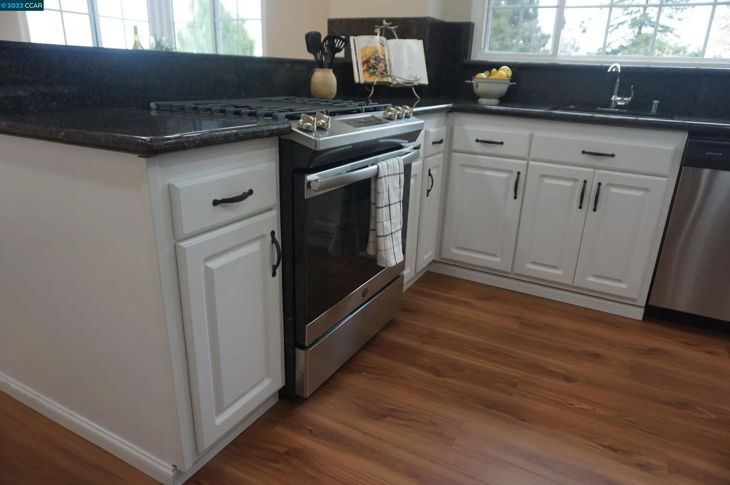 a kitchen with granite countertop a stove and a sink