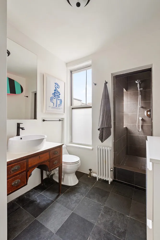 a bathroom with a sink a toilet and a mirror