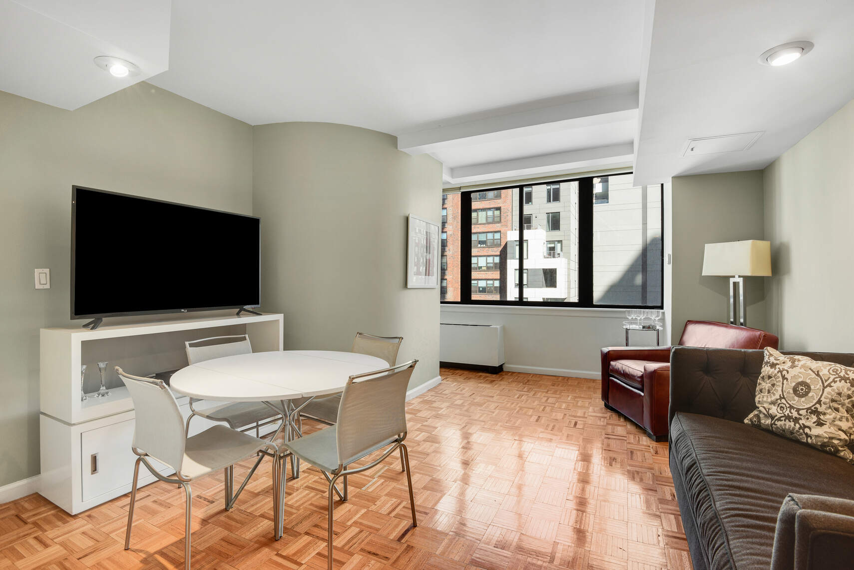 455 East 86th Street, Unit 8D Manhattan, NY 10028 - Photo 2 of 13 a living room with furniture and a flat screen tv