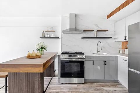 a kitchen with stainless steel appliances a stove and cabinets