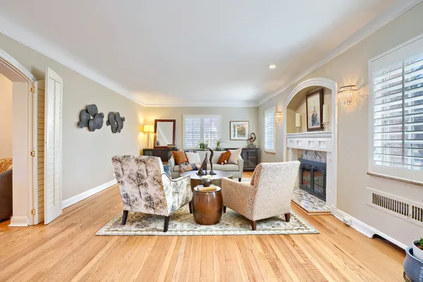 a living room with furniture a wooden floor and a fireplace