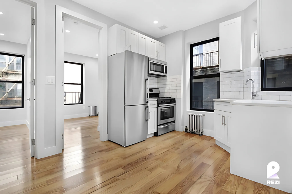 175 East 105th Street, Unit 3R Manhattan, NY 10029 - Photo 1 of 8 a kitchen with stainless steel appliances a refrigerator and a stove top oven