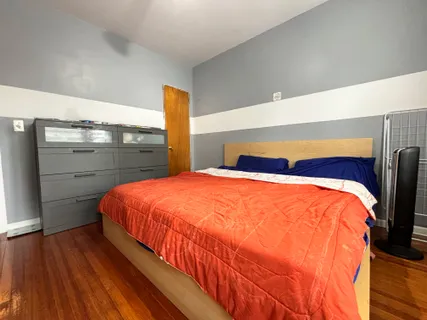 a bedroom with a bed and window