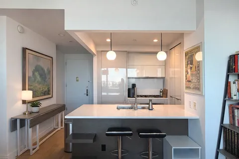 a kitchen with a sink cabinets and window