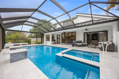 an aerial view of a house with outdoor space swimming pool