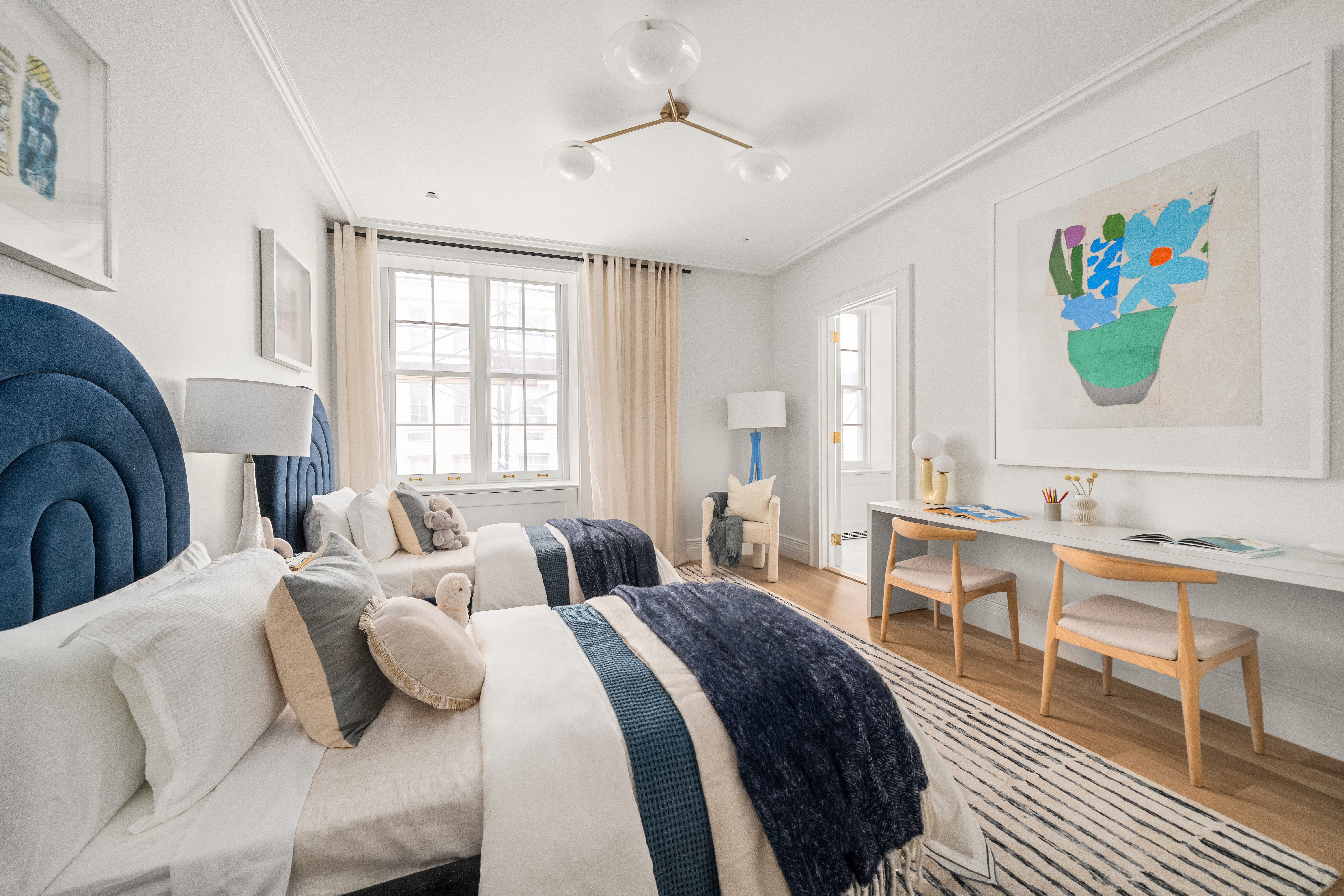 1020 5th Avenue, Unit 9 Manhattan, NY 10028 - Photo 23 of 27 a bedroom with a bed and a chandelier