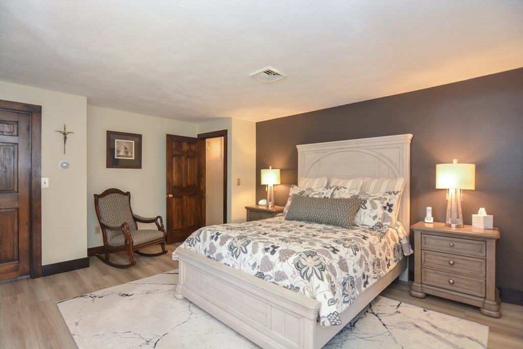 187 Blackstone Street Mendon, MA 01756 - Photo 18 of 42 a bedroom with a bed a table and chair