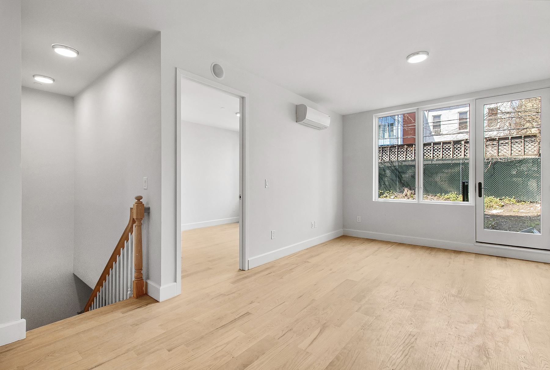 1098 Madison Street, Unit 1B Brooklyn, NY 11221 - Photo 2 of 16 a view of empty room with wooden floor and fan