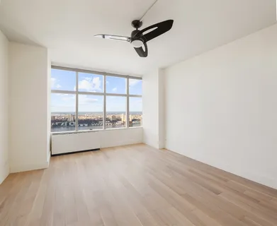 a view of an empty room and a window