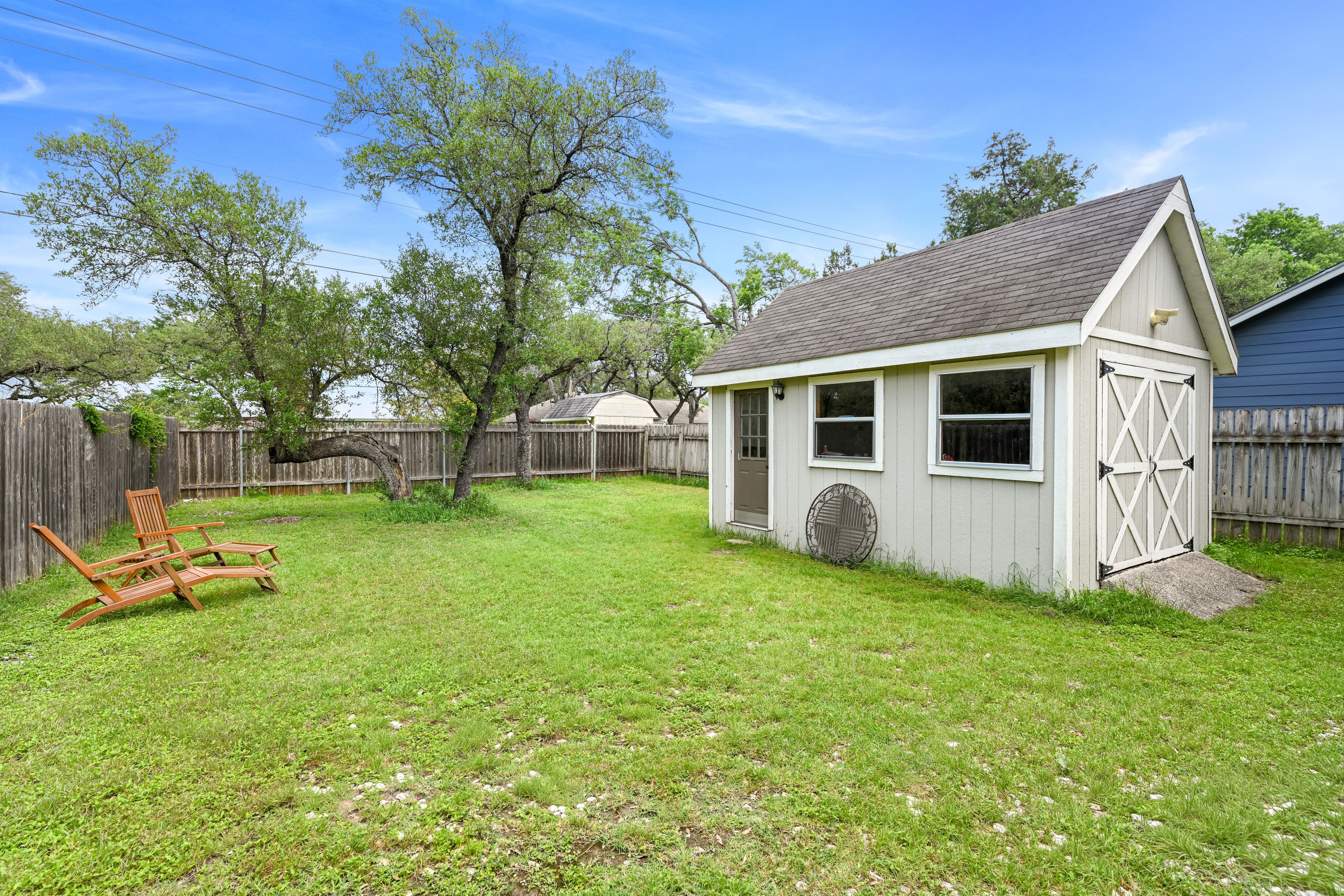 8710 Clearbrook Trail Austin, TX 78729 - Photo 13 of 28 a view of a house with backyard and a tree
