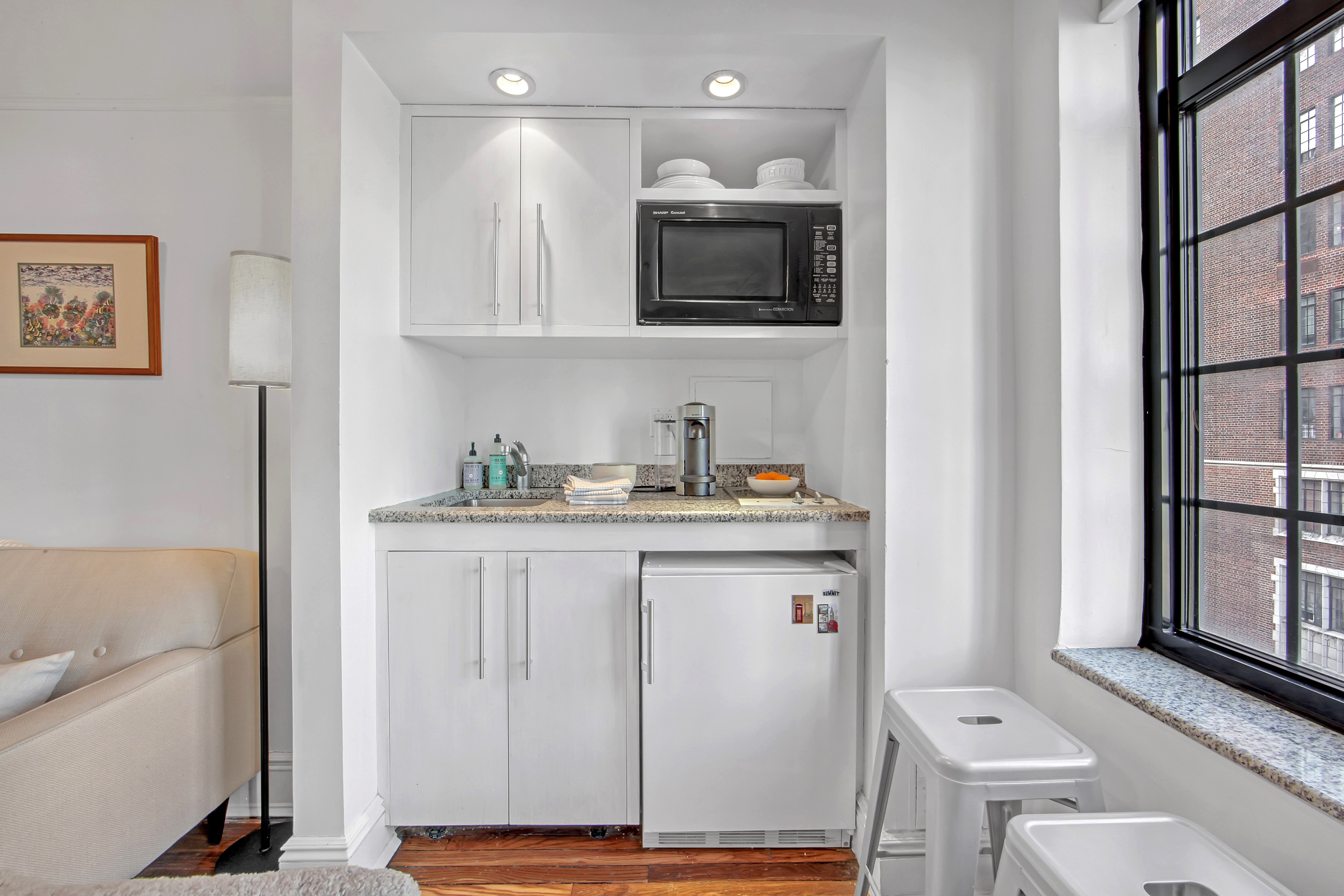 5 Tudor City Place, Unit 539 Manhattan, NY 10017 - Photo 4 of 12 a bathroom with a sink a toilet and mirror