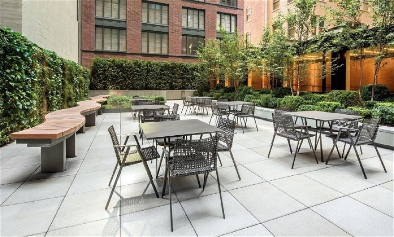 70 Charlton Street, Unit 7E Manhattan, NY 10014 - Photo 13 of 17 a view of a patio with table and chairs and potted plants