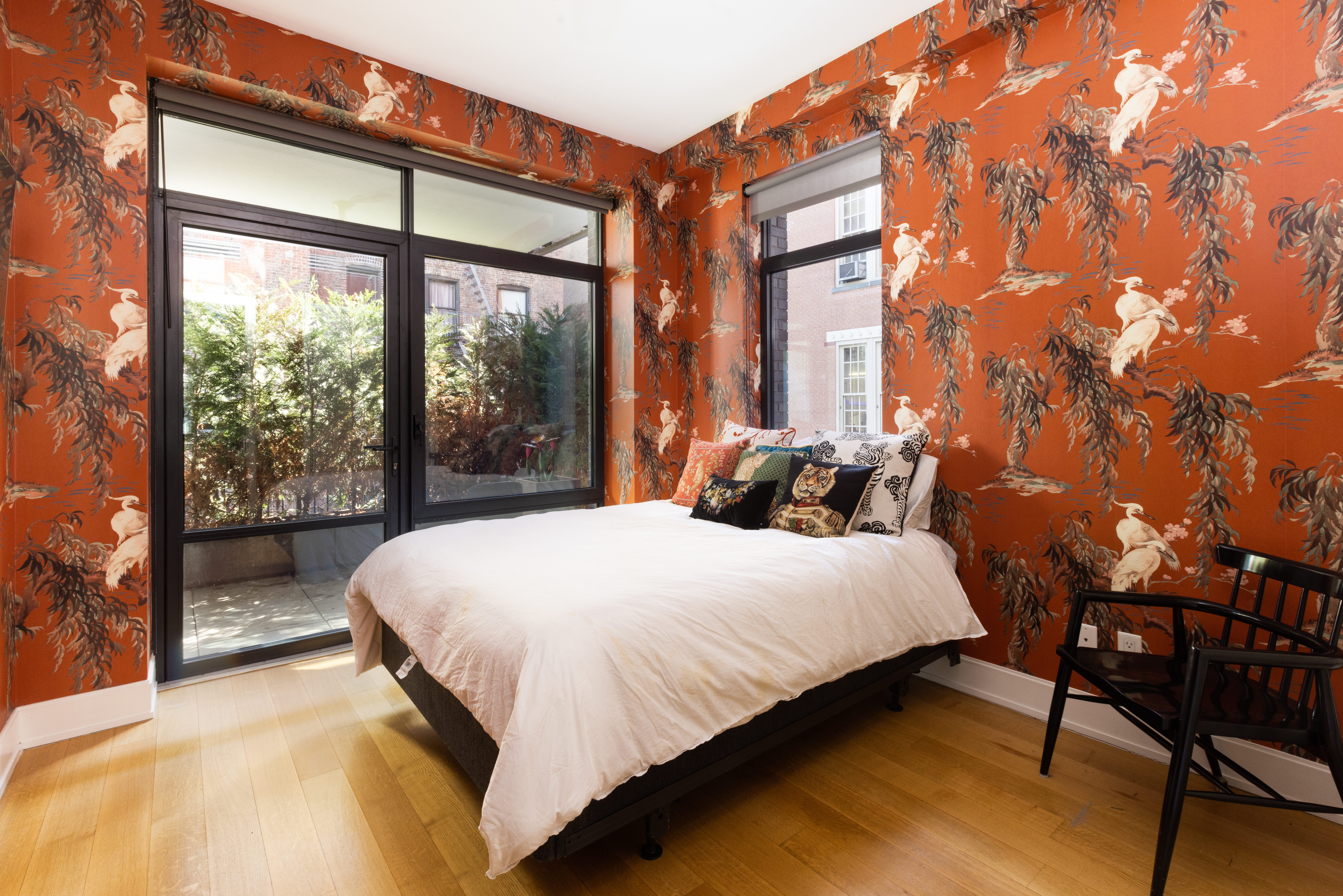 204 Forsyth Street, Unit 3S Manhattan, NY 10002 - Photo 5 of 6 a bed sitting in a bedroom next to a window