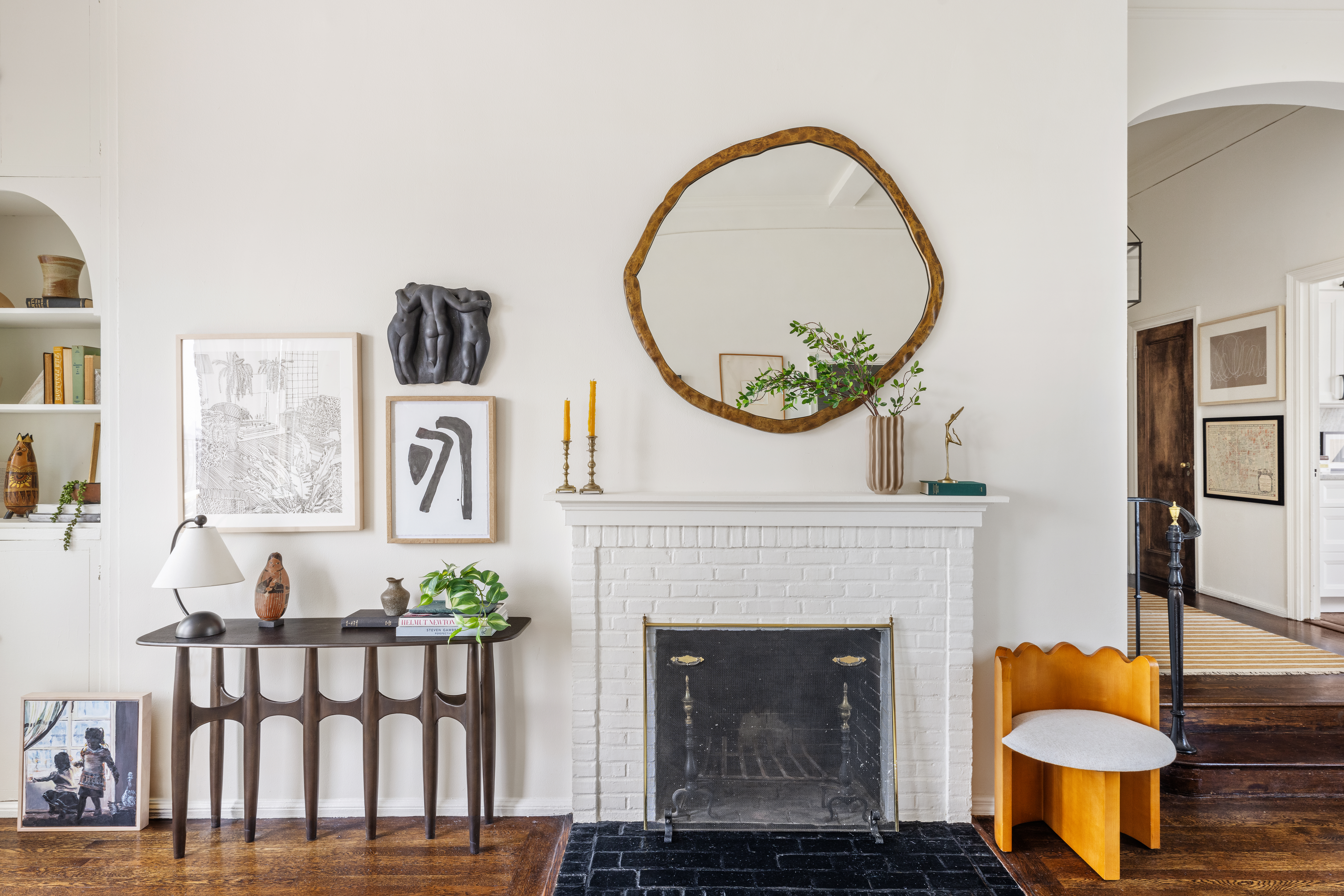 302 West 12th Street, Unit PHE Manhattan, NY 10014 - Photo 8 of 16 a living room with furniture a mirror and a fireplace