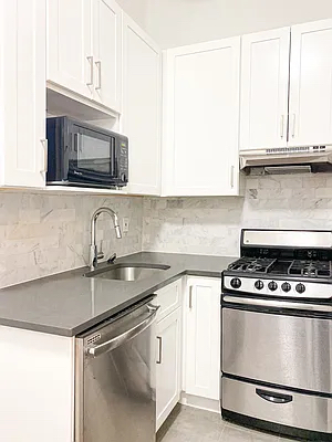 1736 2nd Avenue, Unit C Manhattan, NY 10128 - Photo 2 of 4 a kitchen with granite countertop a sink stainless steel appliances and cabinets