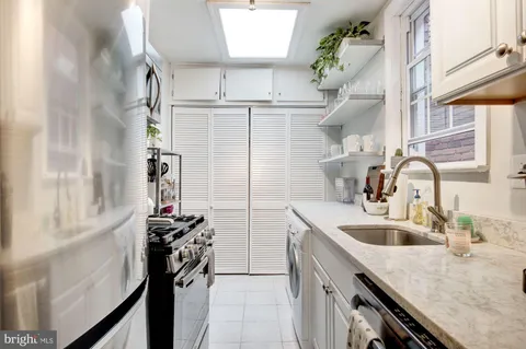 a kitchen with a stove and a white cabinet