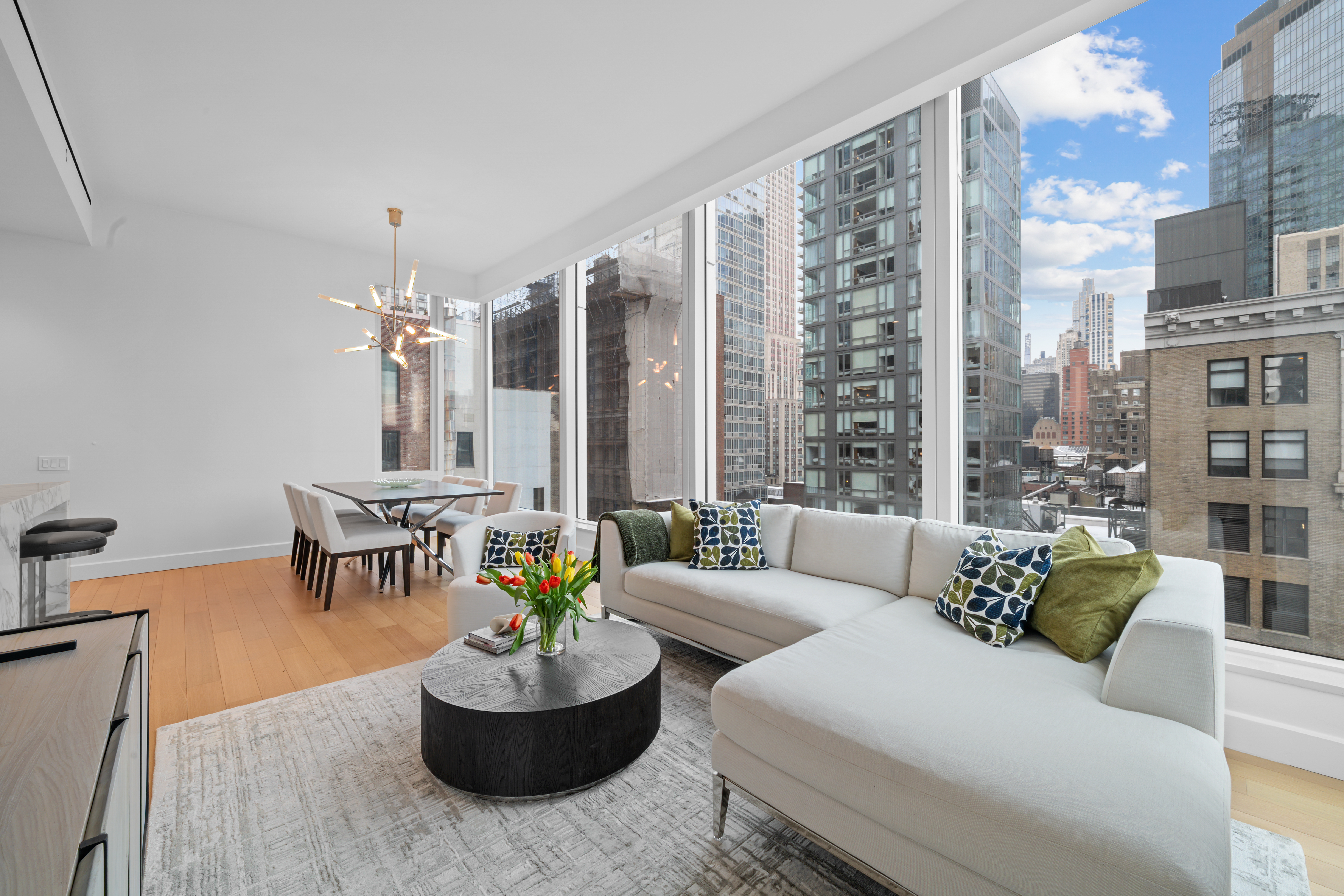 15 East 30th Street, Unit 19B Manhattan, NY 10016 - Photo 9 of 40 a living room with furniture and a large window