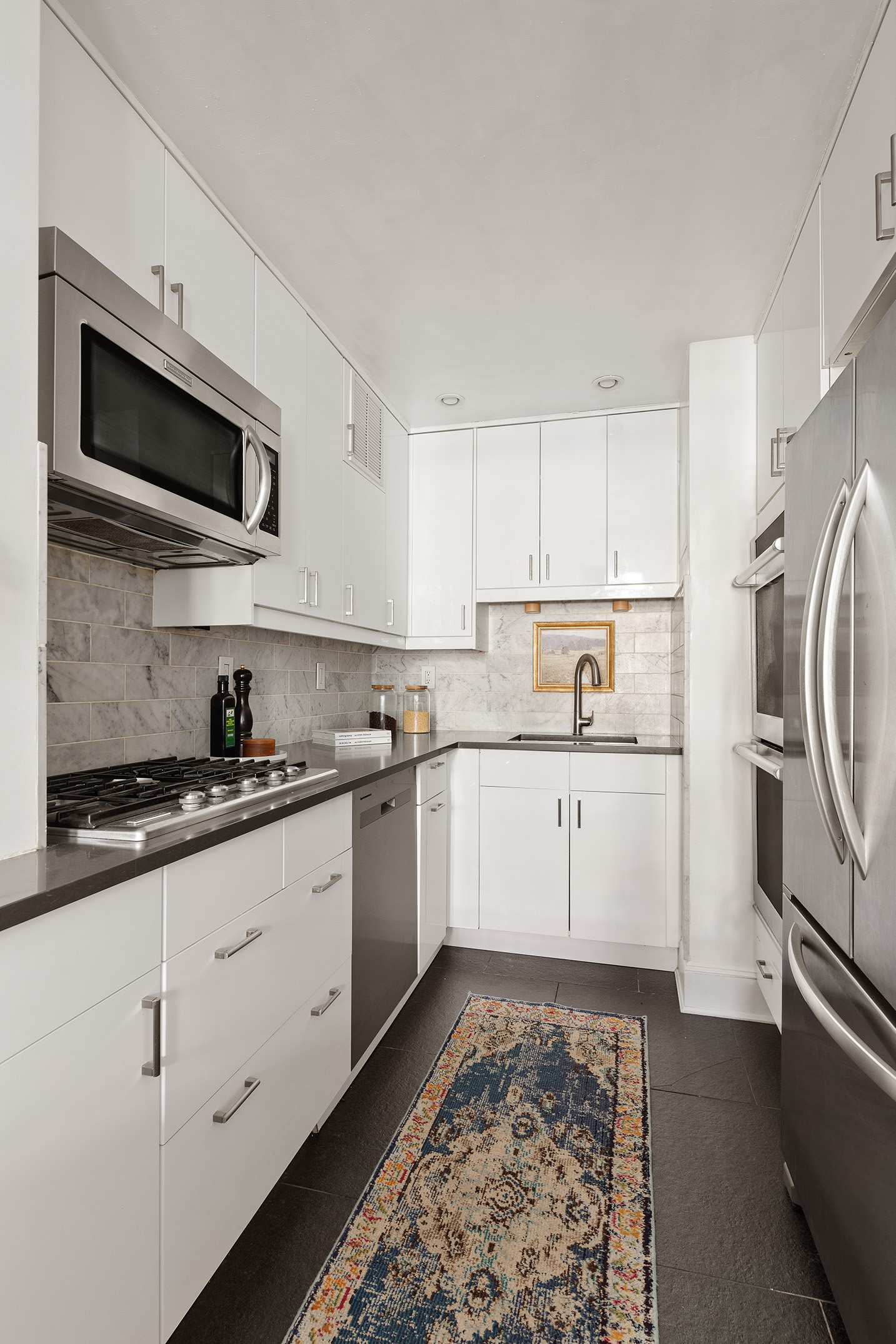 1 Tiffany Place, Unit 2F Brooklyn, NY 11231 - Photo 3 of 12 a kitchen with stainless steel appliances granite countertop a sink and a stove