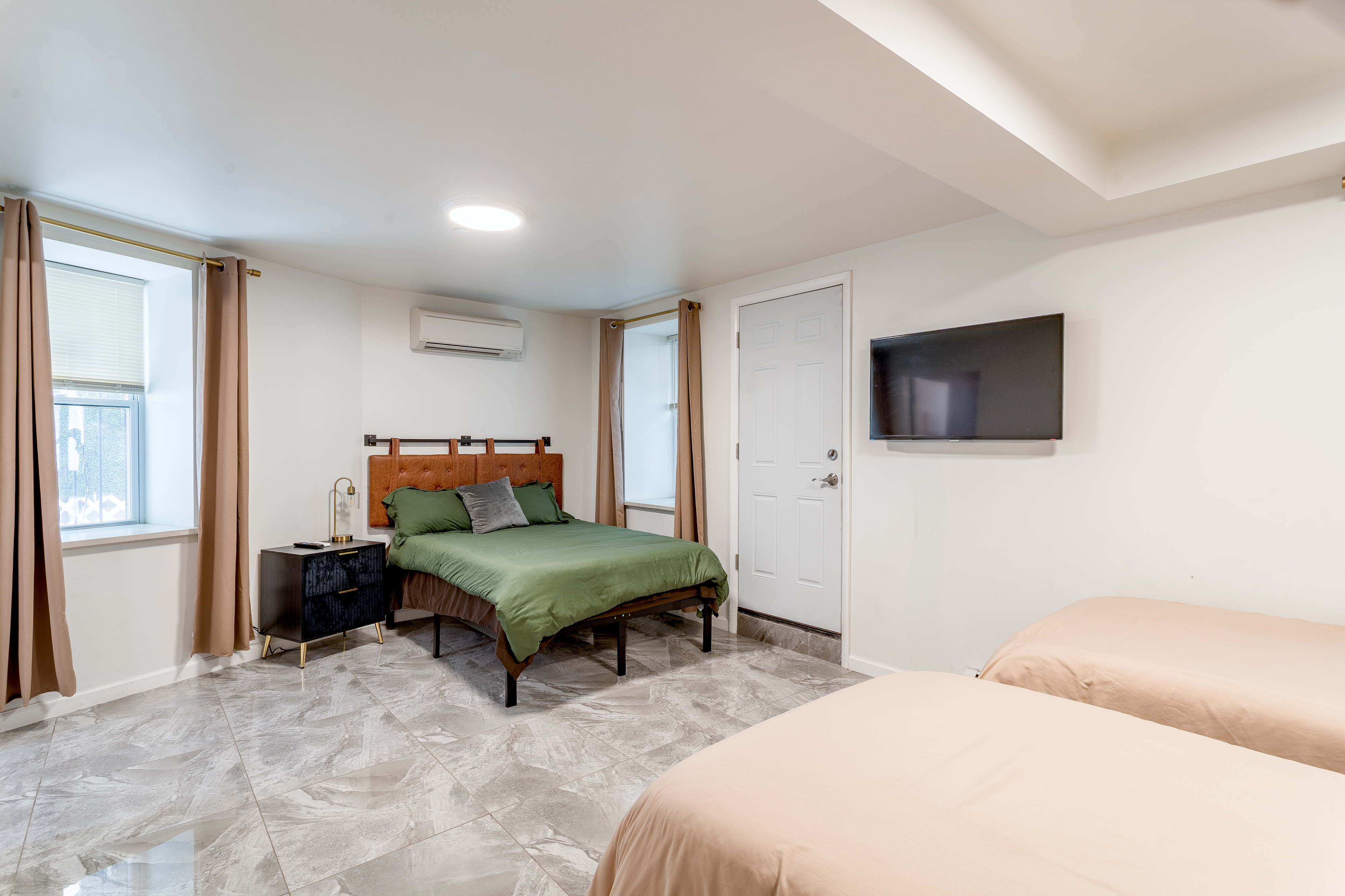 212 East 70th Street, Unit B Manhattan, NY 10021 - Photo 15 of 17 a bedroom with furniture and a flat screen tv