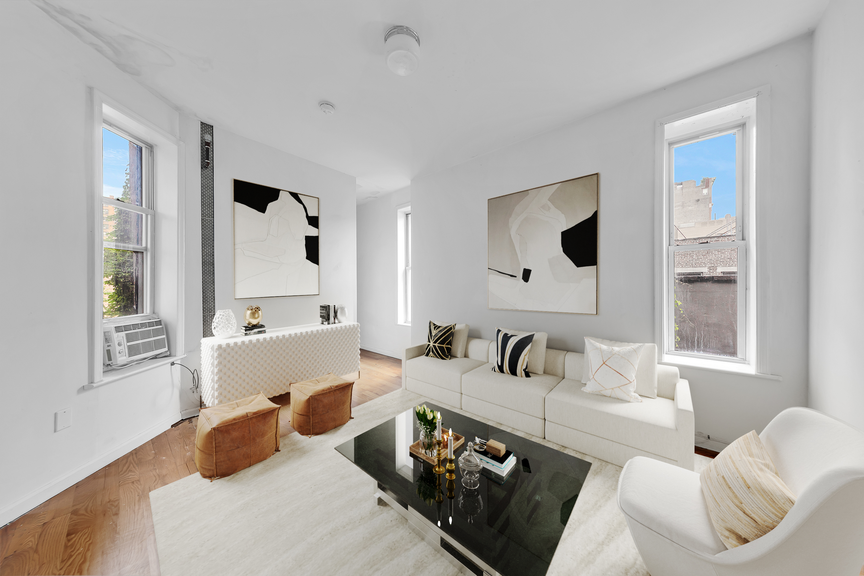 a bedroom with furniture and a large window