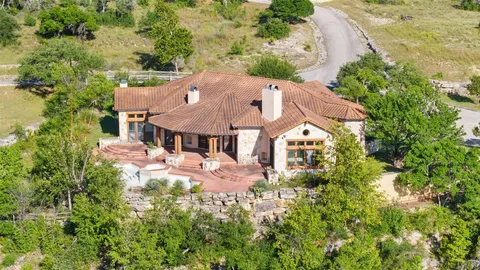 an aerial view of a house with swimming pool and garden