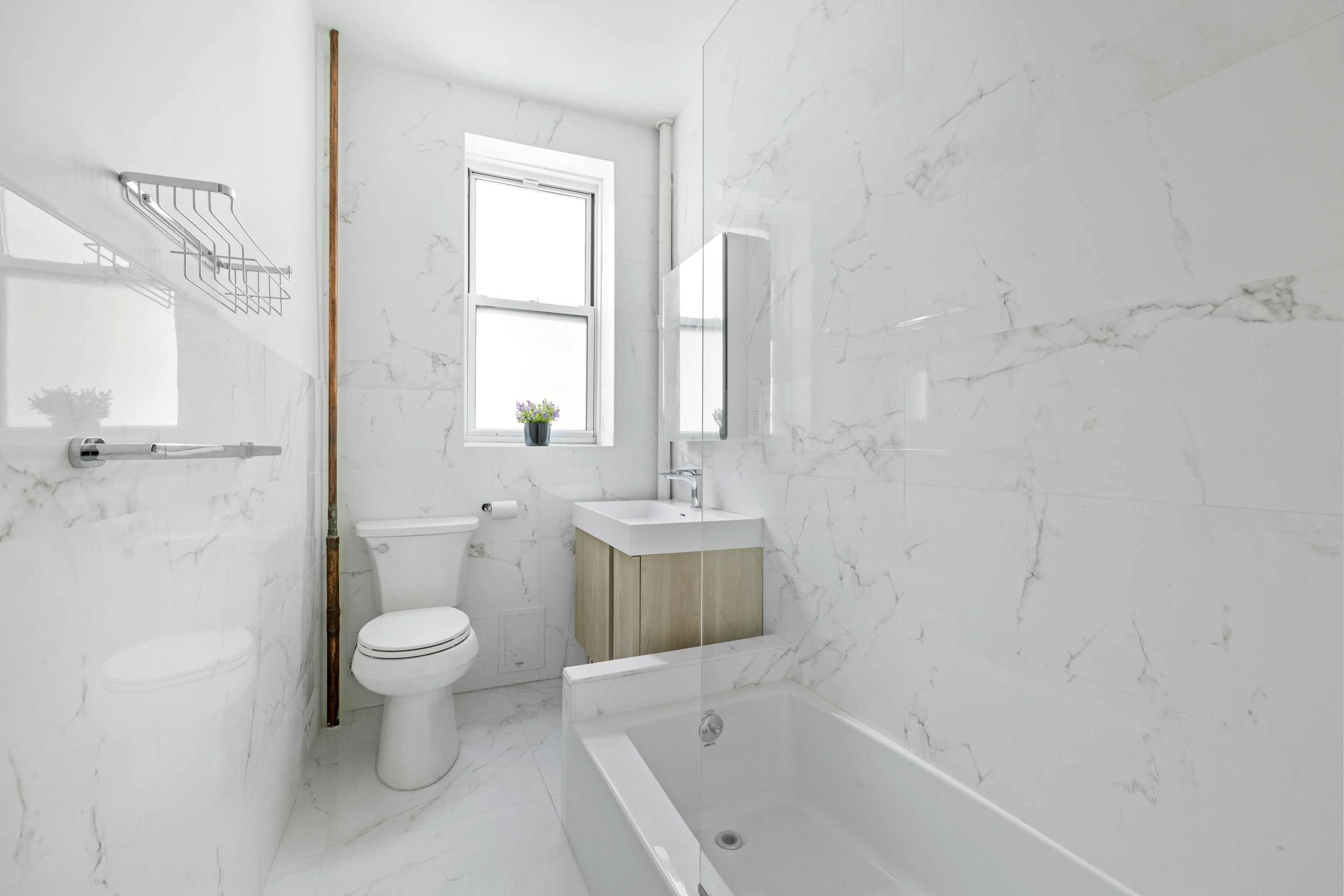 345 West 70th Street, Unit 5F Manhattan, NY 10023 - Photo 8 of 13 a bathroom with a toilet a sink and a bathtub