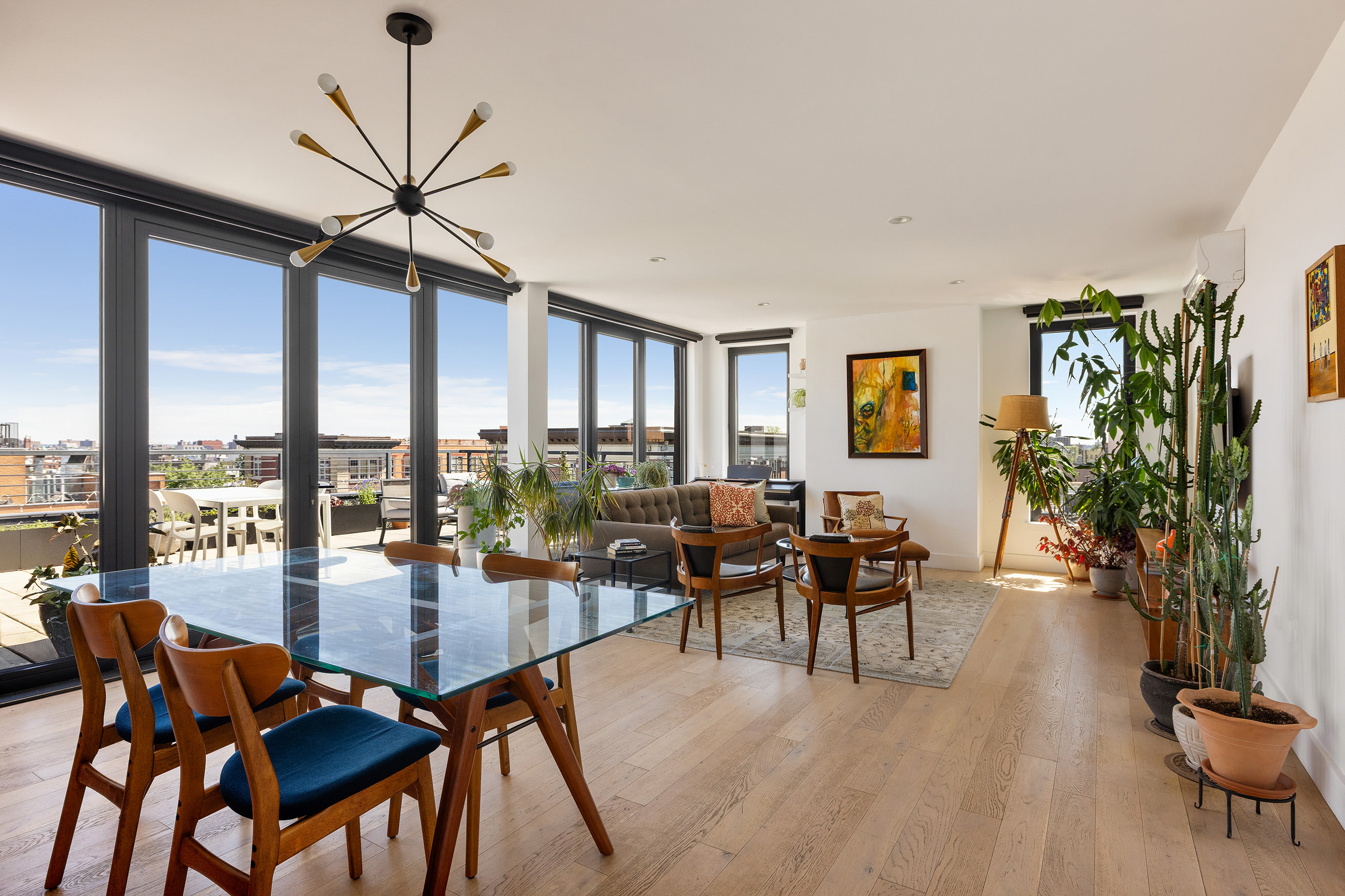 a dining room with furniture window and wooden floor