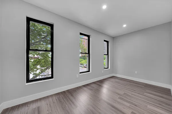 30 Marconi Place, Unit 2 Brooklyn, NY 11233 - Photo 5 of 11 a view of an empty room with wooden floor and window