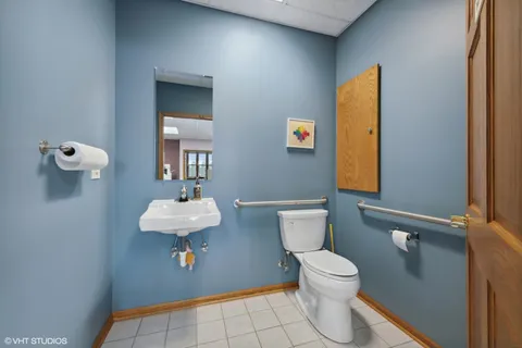 a bathroom with a sink a toilet and mirror