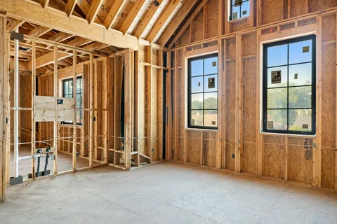 a view of a tennis ground with large trees