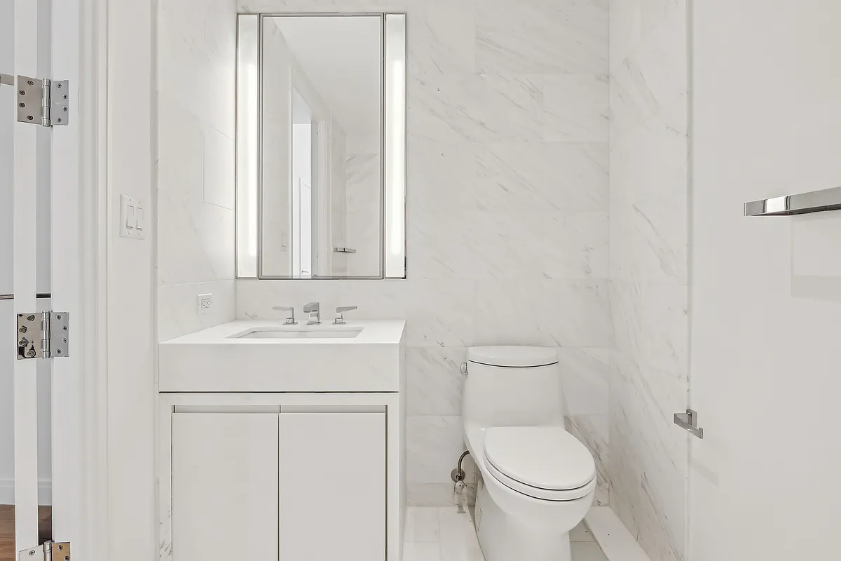 269 West 87th Street, Unit 14A Manhattan, NY 10024 - Photo 12 of 23 a bathroom with a toilet a sink and mirror