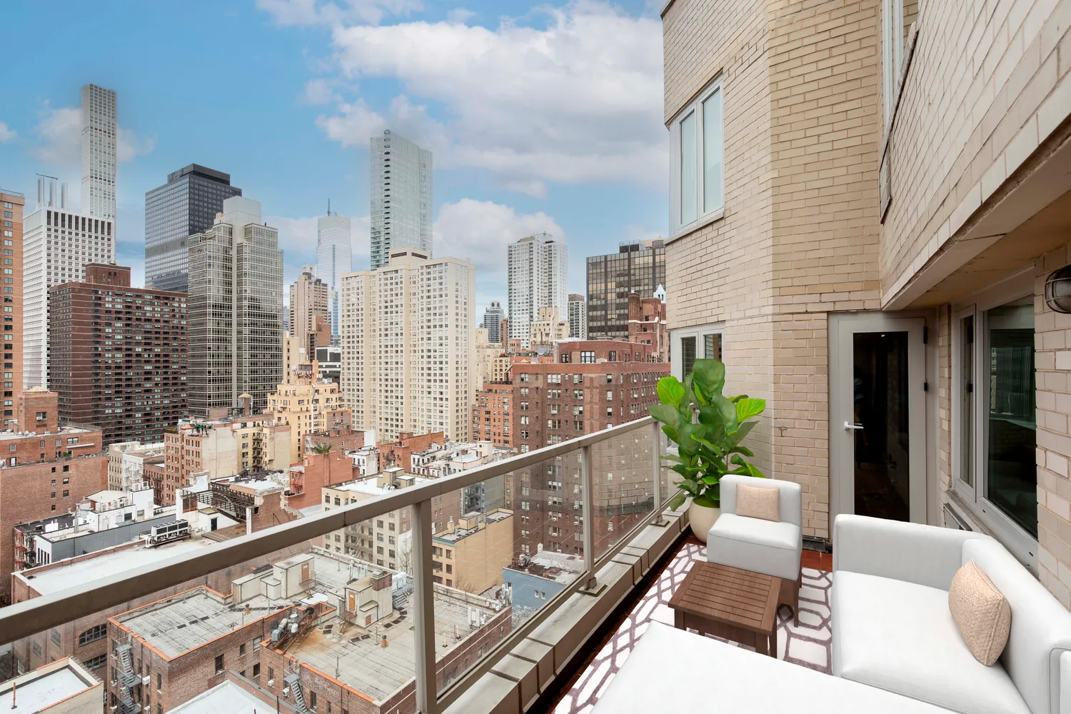 a balcony with furniture and a potted plant